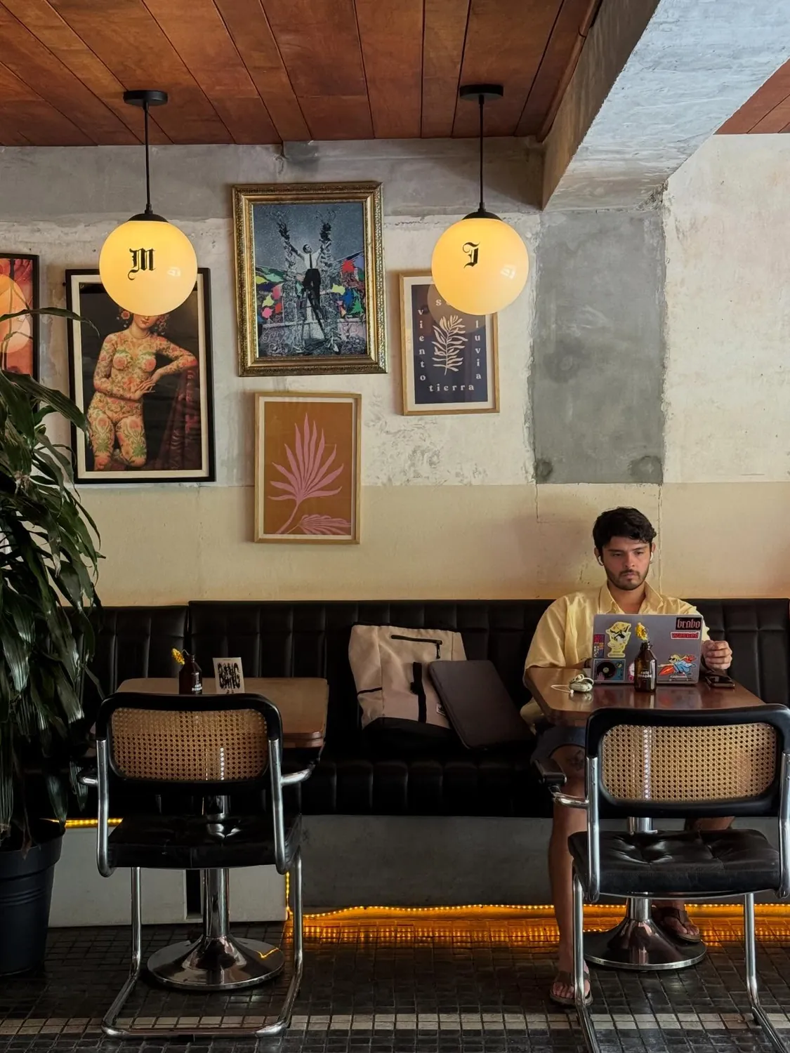 Sebastián trabajando con su portátil en un café de Medellín